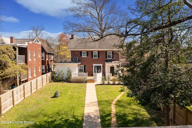 back of property featuring a lawn