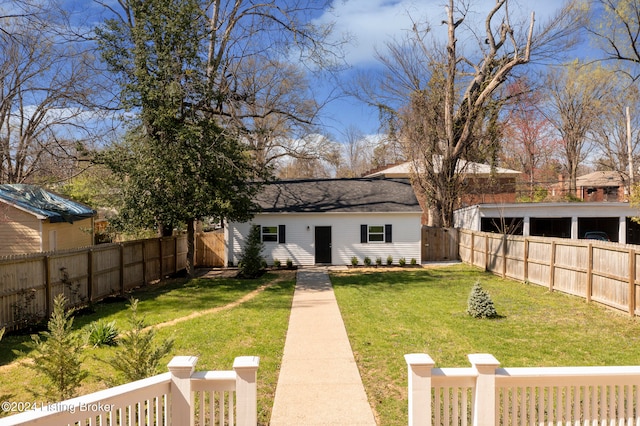 rear view of house featuring a lawn