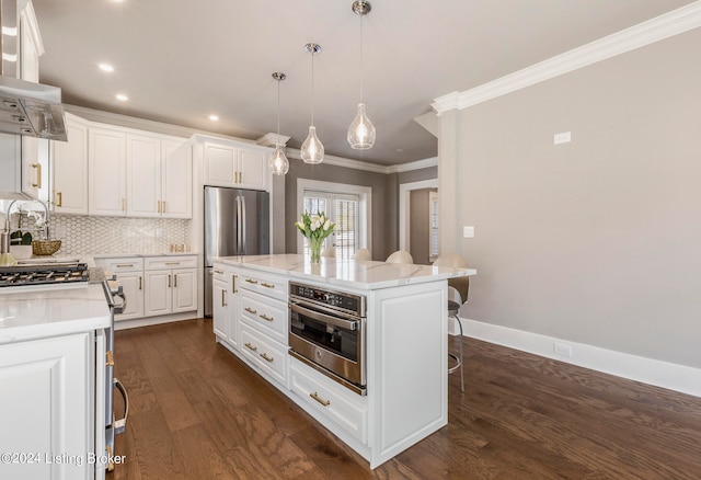 kitchen featuring dark hardwood / wood-style flooring, white cabinetry, and a kitchen breakfast bar