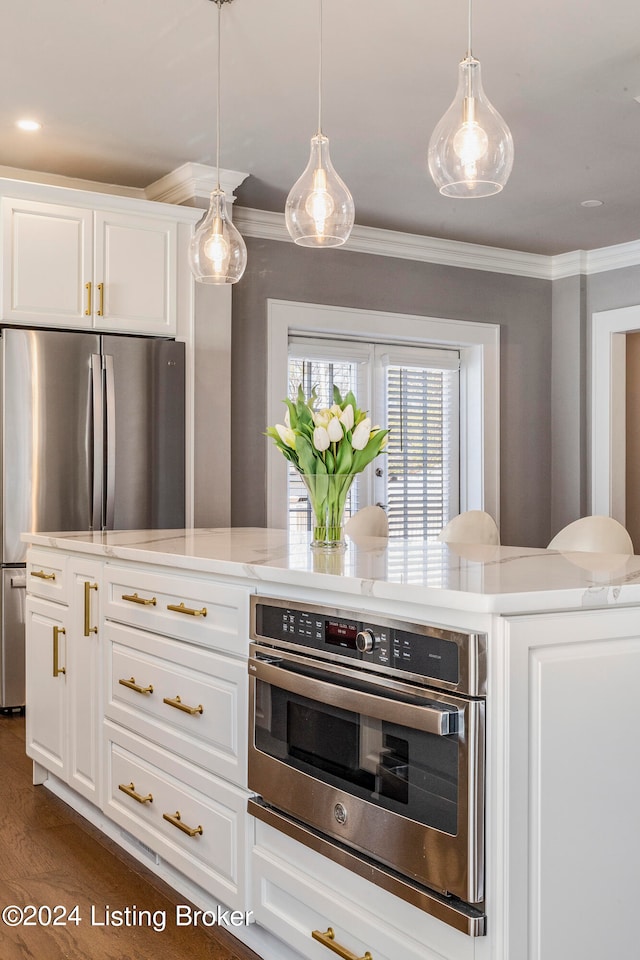 kitchen with decorative light fixtures, white cabinetry, stainless steel appliances, wood-type flooring, and light stone countertops