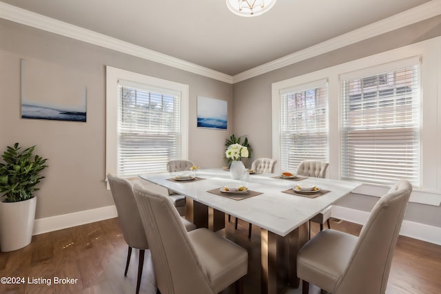 dining space featuring dark wood-type flooring and ornamental molding