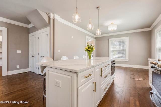 kitchen with dark hardwood / wood-style flooring, hanging light fixtures, a kitchen bar, and white cabinetry