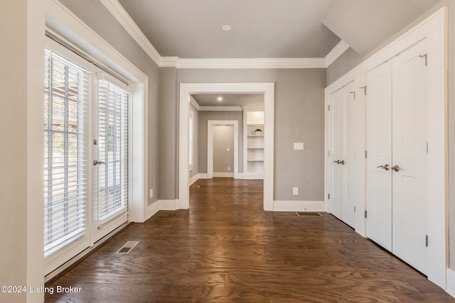 unfurnished bedroom featuring dark hardwood / wood-style floors, ornamental molding, and access to exterior