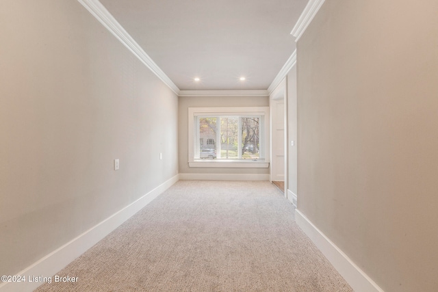 carpeted spare room with crown molding