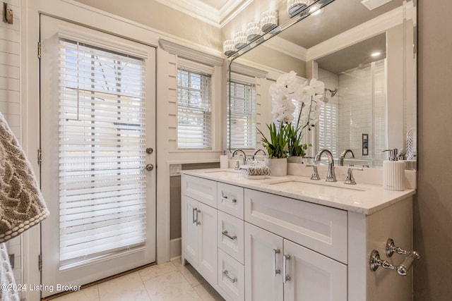 bathroom featuring double sink, tile floors, crown molding, and vanity with extensive cabinet space