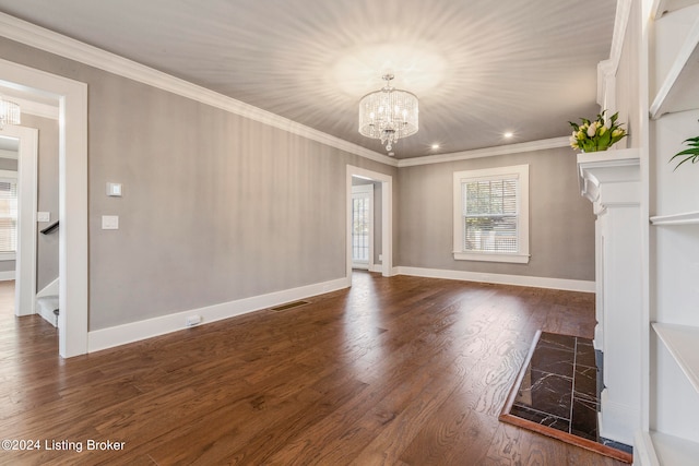 unfurnished living room with dark hardwood / wood-style floors, an inviting chandelier, and ornamental molding