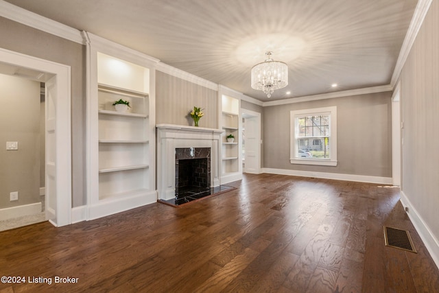 unfurnished living room featuring a fireplace, ornamental molding, a notable chandelier, and dark hardwood / wood-style flooring