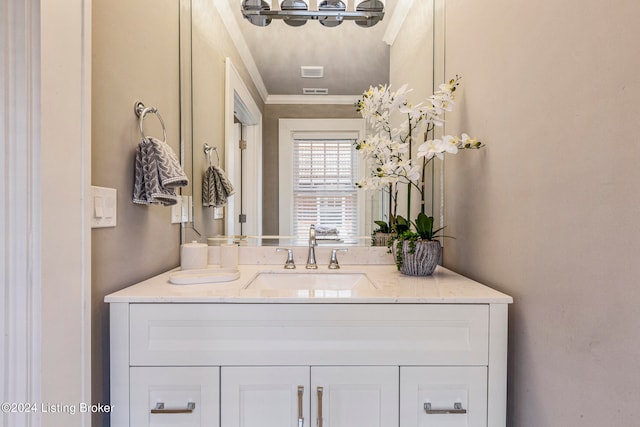 bathroom featuring ornamental molding and vanity