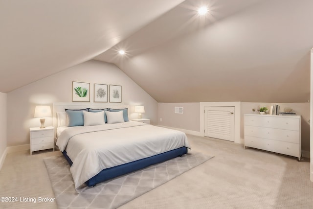 carpeted bedroom with vaulted ceiling