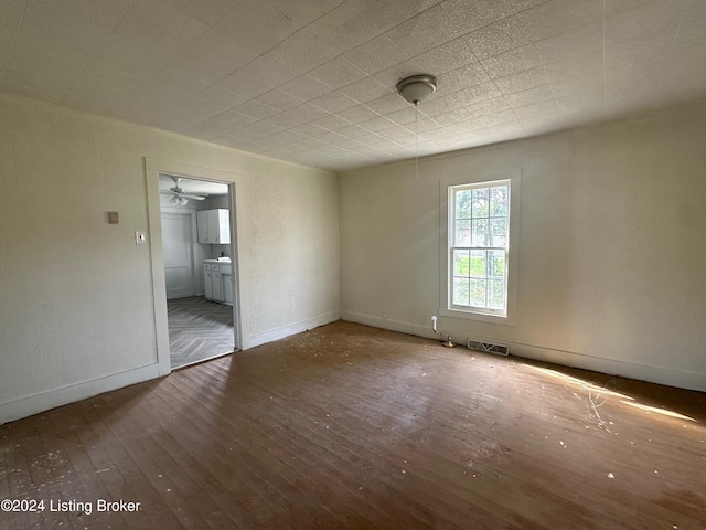 empty room featuring ceiling fan and dark hardwood / wood-style floors