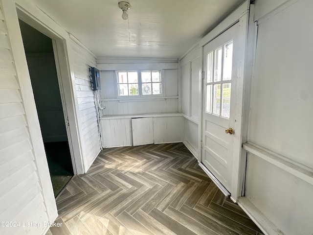 hallway with plenty of natural light and dark parquet floors