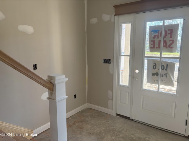 foyer with concrete floors and a healthy amount of sunlight