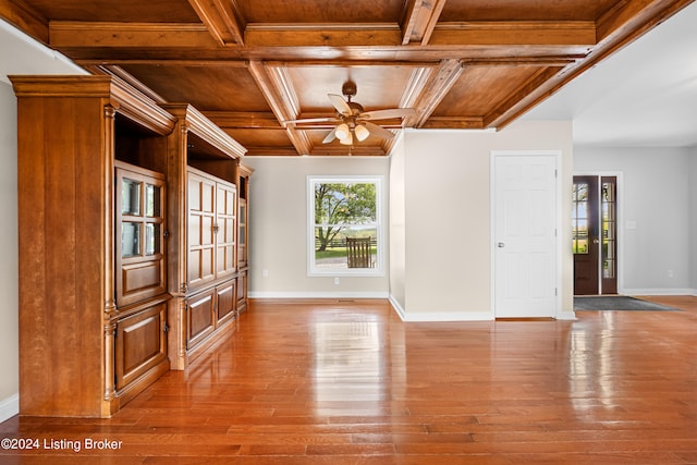 spare room featuring coffered ceiling, beam ceiling, ceiling fan, and hardwood / wood-style floors