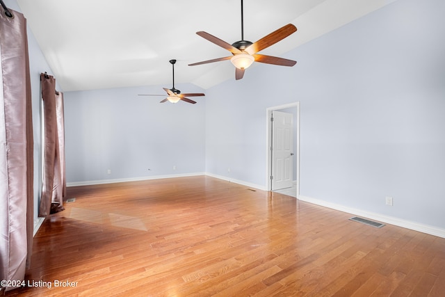 empty room with high vaulted ceiling, ceiling fan, and light wood-type flooring