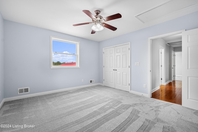 carpeted spare room with ceiling fan