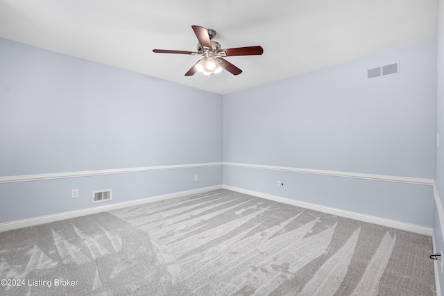 spare room featuring ceiling fan and carpet floors