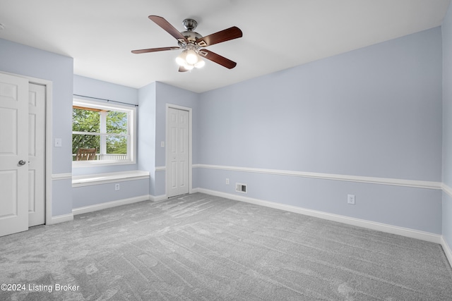 unfurnished bedroom featuring ceiling fan and carpet flooring