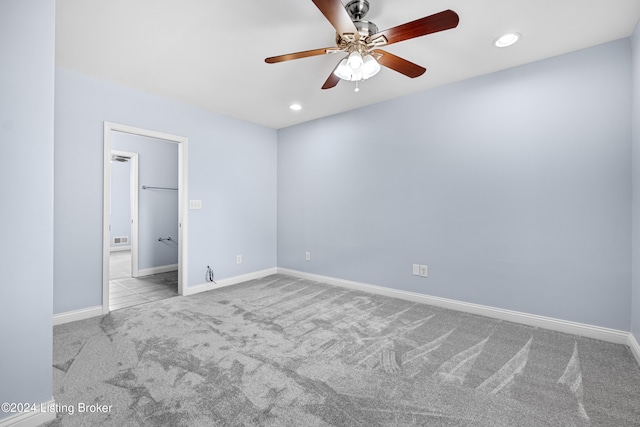 carpeted empty room with ceiling fan