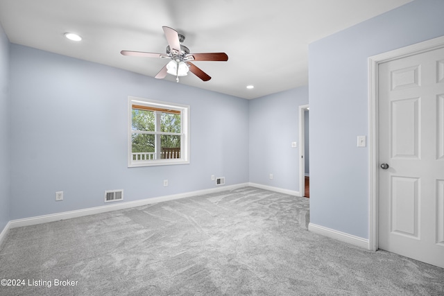 spare room featuring carpet floors and ceiling fan