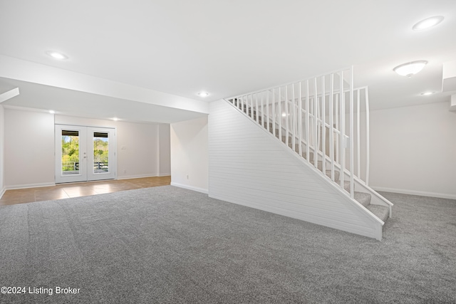 basement with french doors and carpet floors