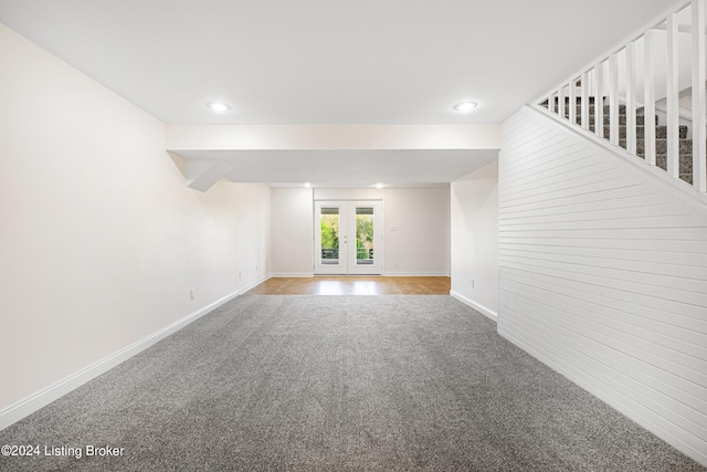 unfurnished room with beamed ceiling, french doors, and carpet