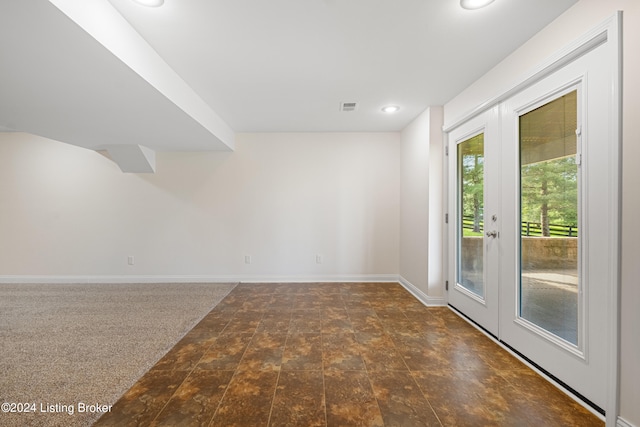 tiled empty room featuring french doors