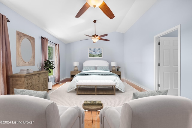 bedroom with vaulted ceiling, ceiling fan, and light hardwood / wood-style flooring