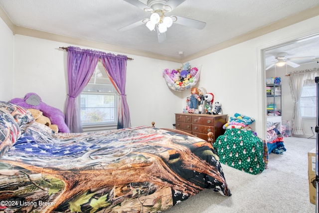 carpeted bedroom with a ceiling fan and a textured ceiling