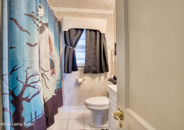 full bath with vanity, wallpapered walls, a textured ceiling, toilet, and tile patterned floors