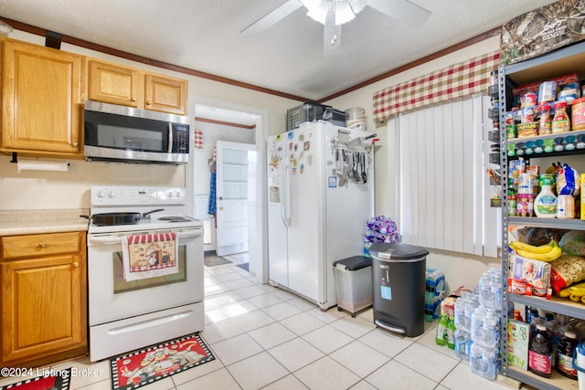 kitchen featuring a ceiling fan, light tile patterned floors, light countertops, ornamental molding, and white appliances