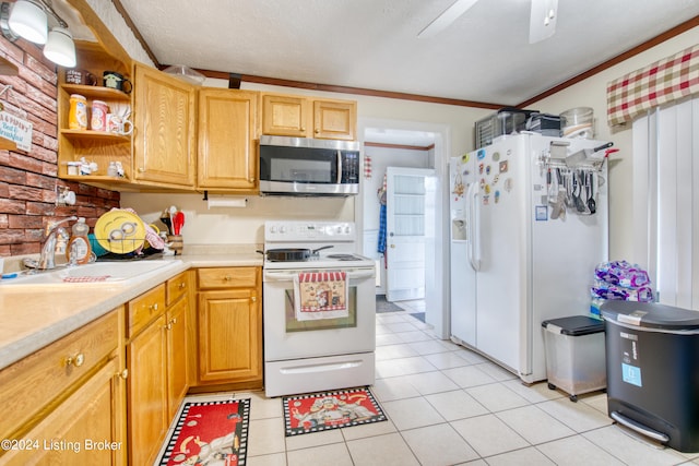 kitchen with light tile patterned flooring, light countertops, a sink, white appliances, and ceiling fan