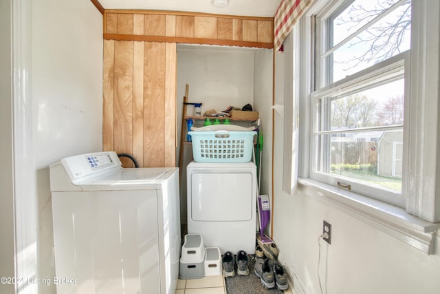 laundry room with washing machine and dryer, laundry area, and tile patterned flooring