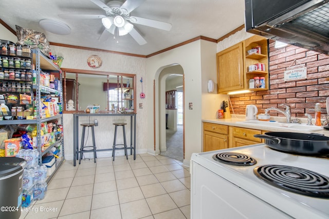 kitchen featuring ornamental molding, light countertops, white range with electric stovetop, light tile patterned flooring, and arched walkways