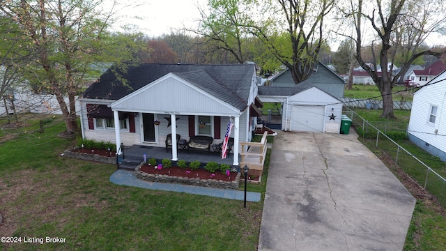 bungalow featuring an outbuilding, roof with shingles, a detached garage, a porch, and a front yard