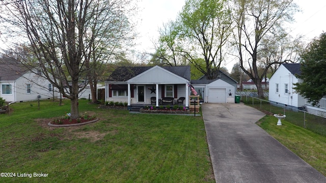 view of front of home with fence, concrete driveway, a front lawn, covered porch, and a detached garage