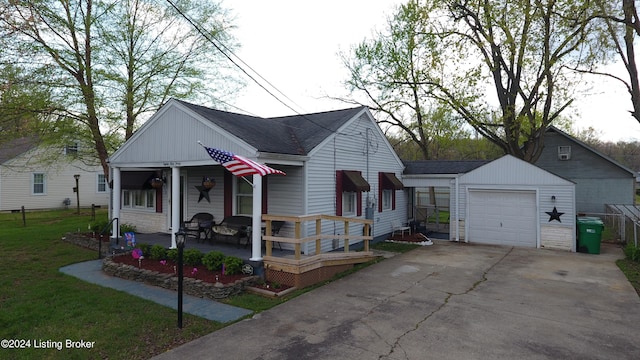 bungalow-style home with a front lawn, driveway, an outdoor structure, a porch, and a detached garage