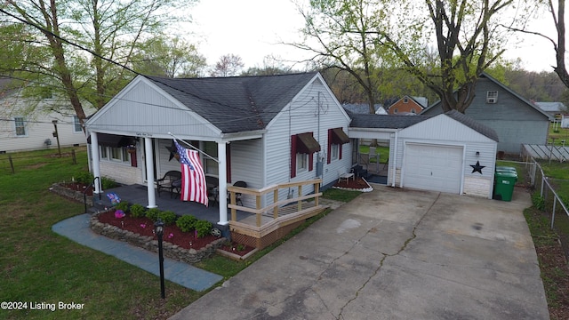 view of front of home featuring a front lawn, a shingled roof, covered porch, and driveway