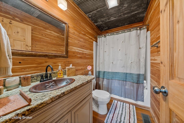 1478 Robbin Ln, Cub Run, KY 42729 - bathroom featuring toilet, vanity, wooden walls, visible vents, and shower / bath combination with curtain