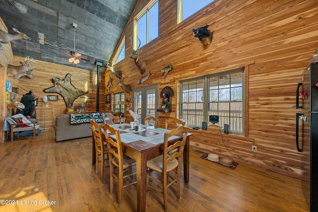 1478 Robbin Ln, Cub Run, KY 42729 - dining space featuring a towering ceiling, a ceiling fan, wood walls, and wood-type flooring