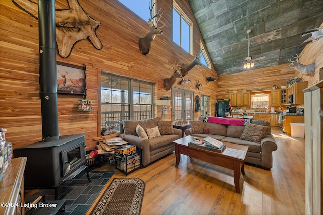 1478 Robbin Ln, Cub Run, KY 42729 - living area with ceiling fan, light wood-type flooring, wood walls, and a wood stove