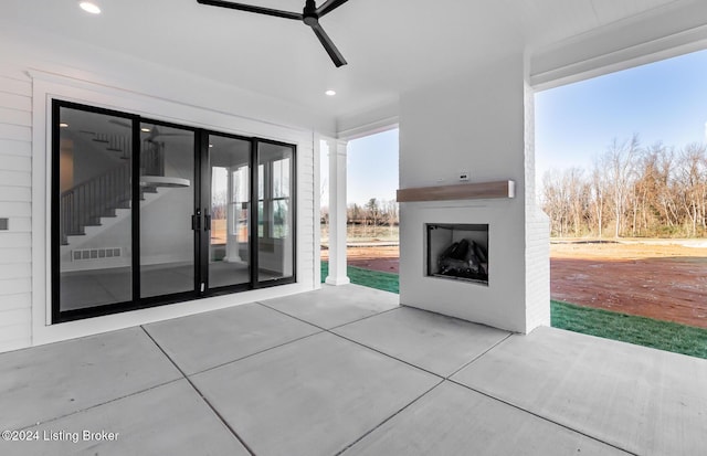 view of patio / terrace featuring an outdoor fireplace