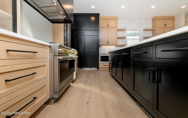 kitchen with light brown cabinets, light wood-type flooring, and appliances with stainless steel finishes