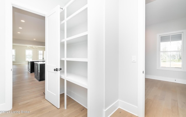 hallway with hardwood / wood-style flooring and a wealth of natural light