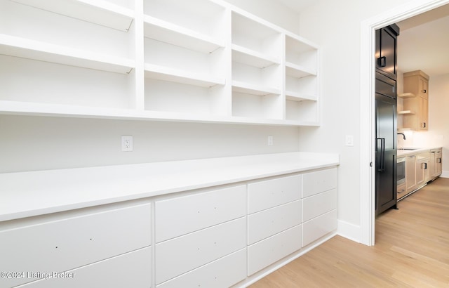 interior space with sink and light hardwood / wood-style flooring