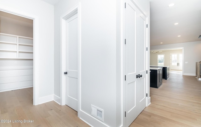 hallway with light hardwood / wood-style flooring