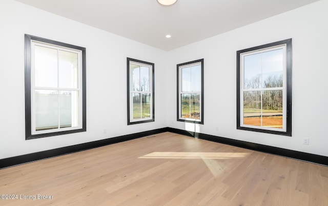 unfurnished room featuring light hardwood / wood-style floors