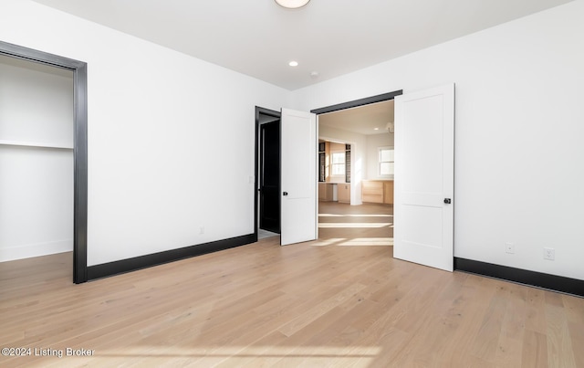 unfurnished bedroom with light wood-type flooring