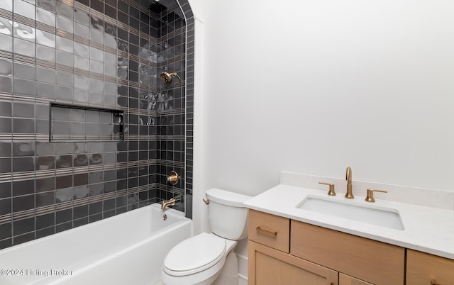 full bathroom with tiled shower / bath combo, toilet, and vanity