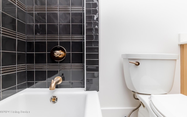 bathroom with a washtub and toilet