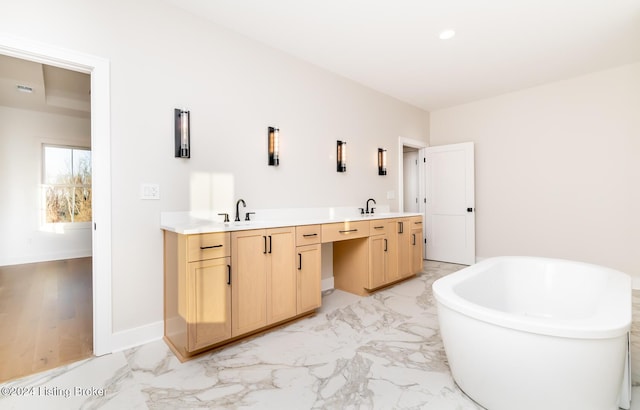 bathroom with hardwood / wood-style floors, vanity, and a bathtub